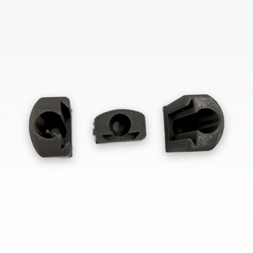 Photo of the grey finger bodies and mount coupon from above, showing the screw bore and the dovetail slot openings