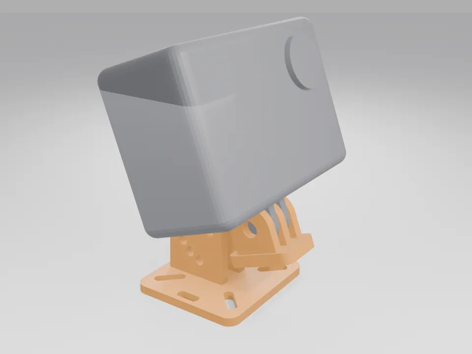 A plain grey box the size of an action camera sitting on the orange TPU mount, which is tilted up on its two ears