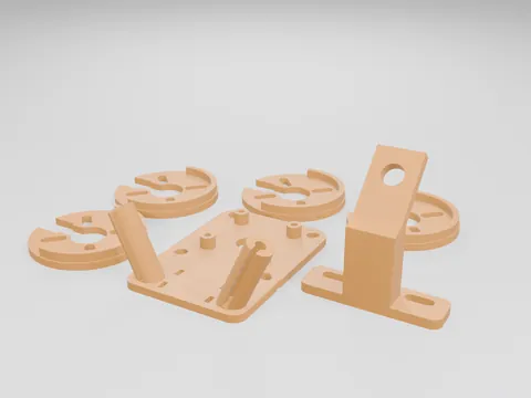 Orange 3D printed TPU parts laid out: four round motor bumpers with curved slots, a square tray with two angled masts and a block-shaped antenna mount