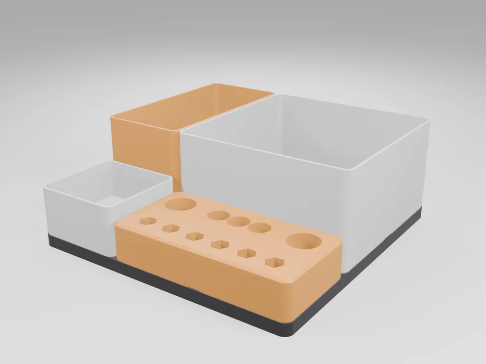 3D printed organiser set on a black 3x3 baseplate: white bins, an orange bin and an orange tool block with hex-bit pockets