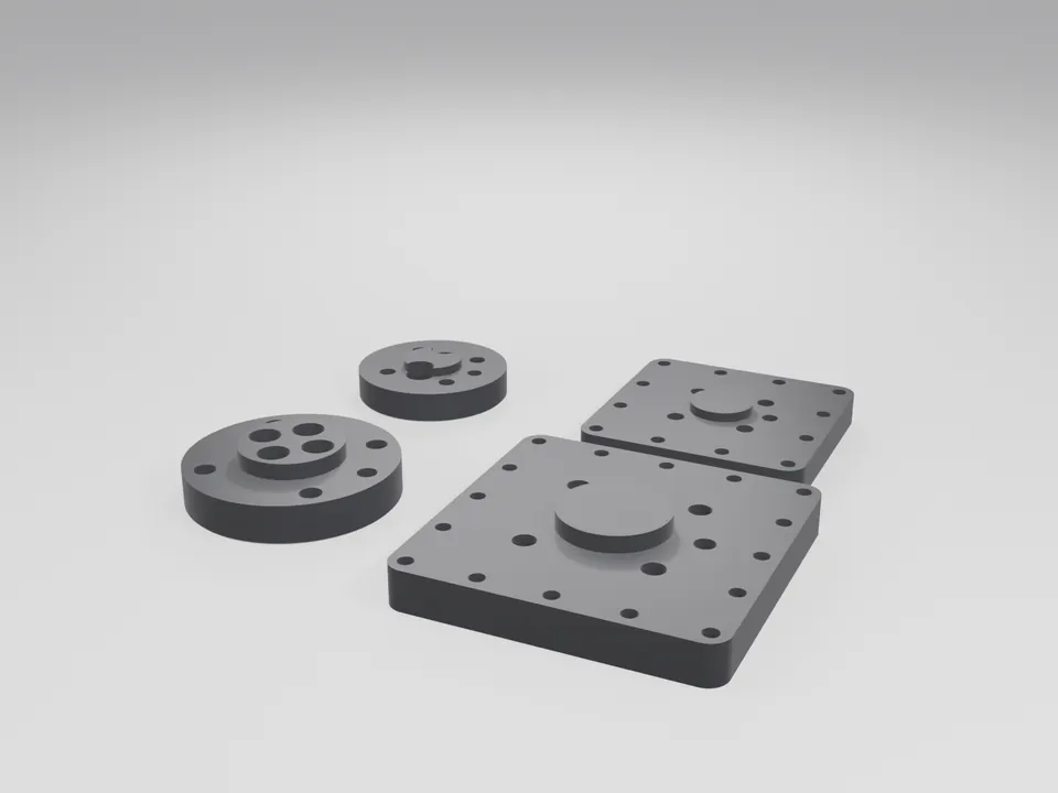 Two round and two square grey 3D printed ISO 9409-1 flange adapters with counterbored bolt holes and a central pilot boss