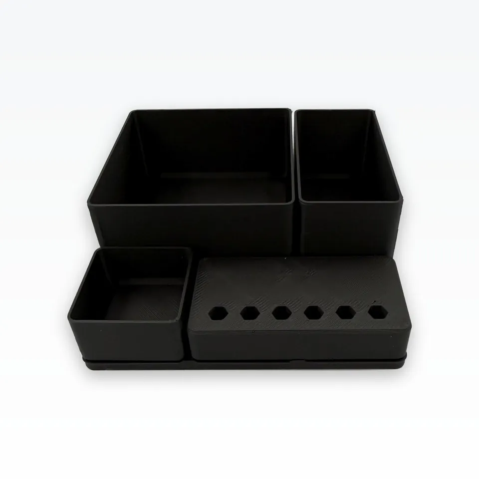 Black 3D printed 42 mm grid organiser set: two tall bins, a small bin and a tool block on a baseplate