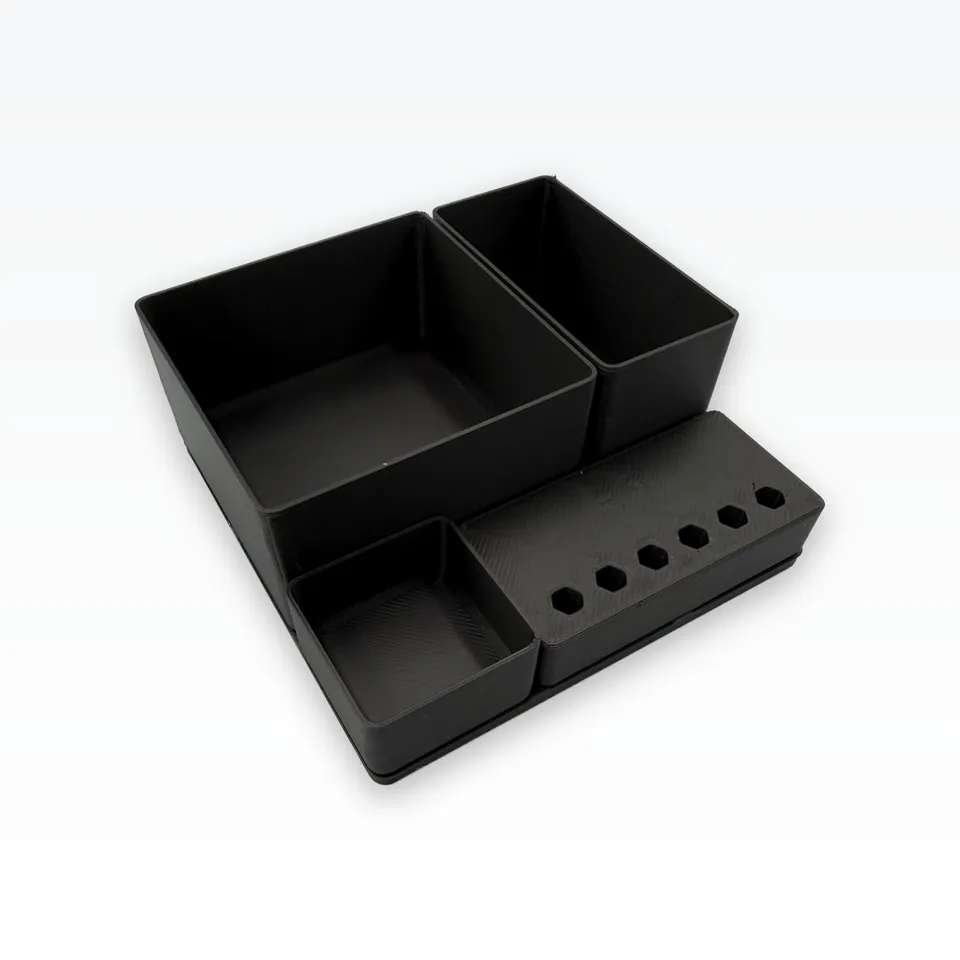 Black 3D printed organiser bins and tool block seen from above at an angle