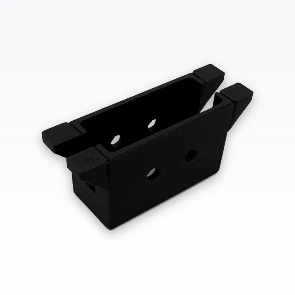 Black 3D printed servo bracket seen from an angle, showing the servo window and M5 face holes